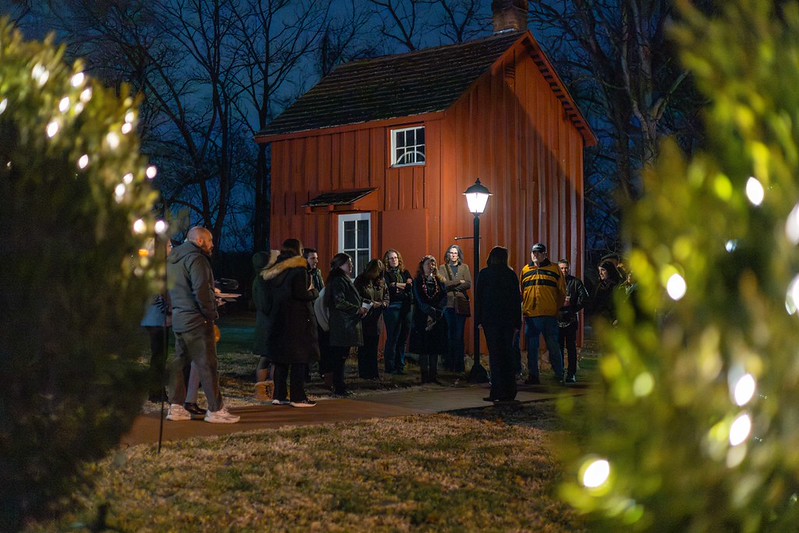 A red cabin at Woodlawn Manor lit up at night.